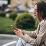 Woman using cellphone in park