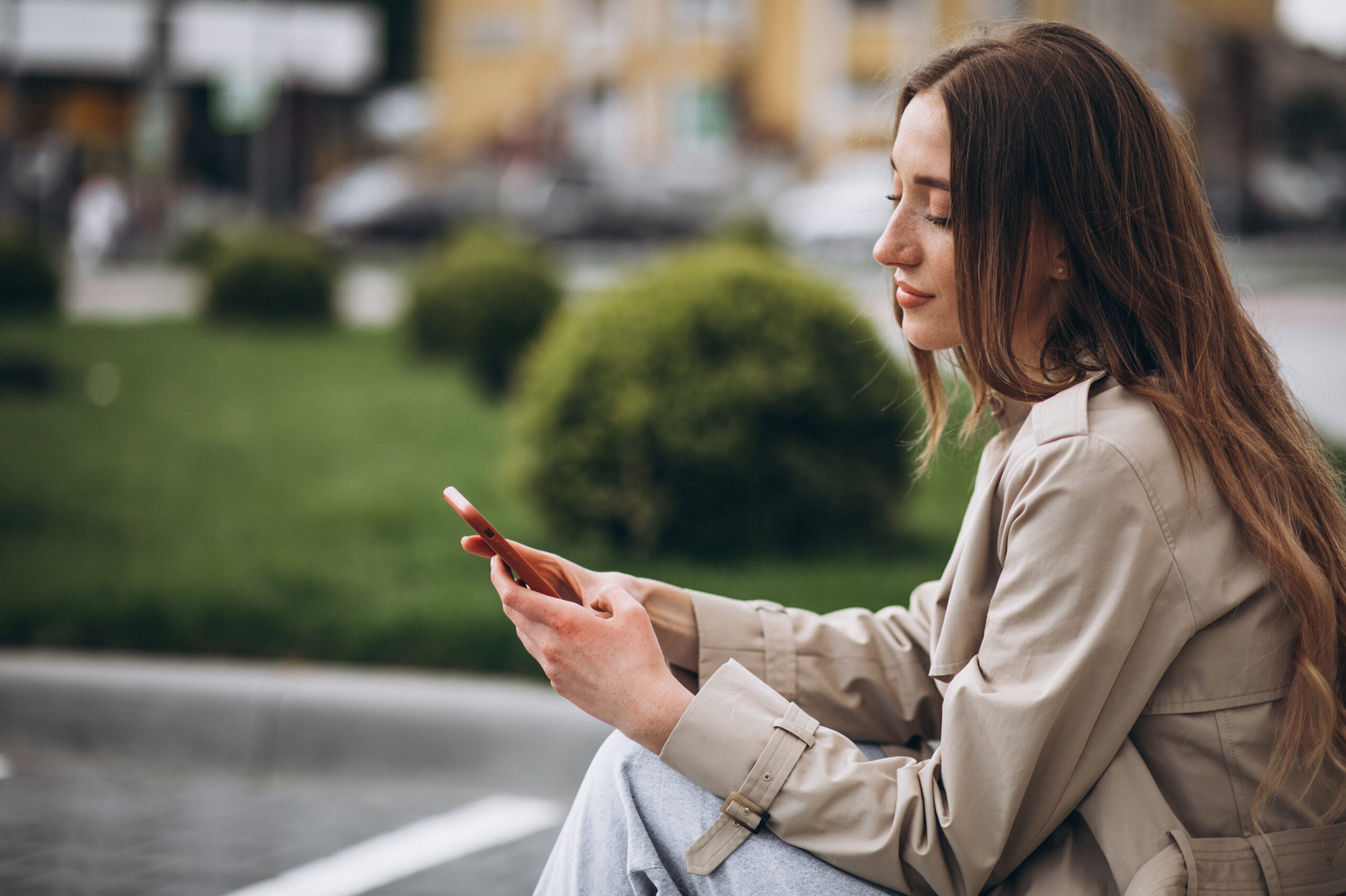 Woman using cellphone in park