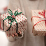 Hands holding gift boxes