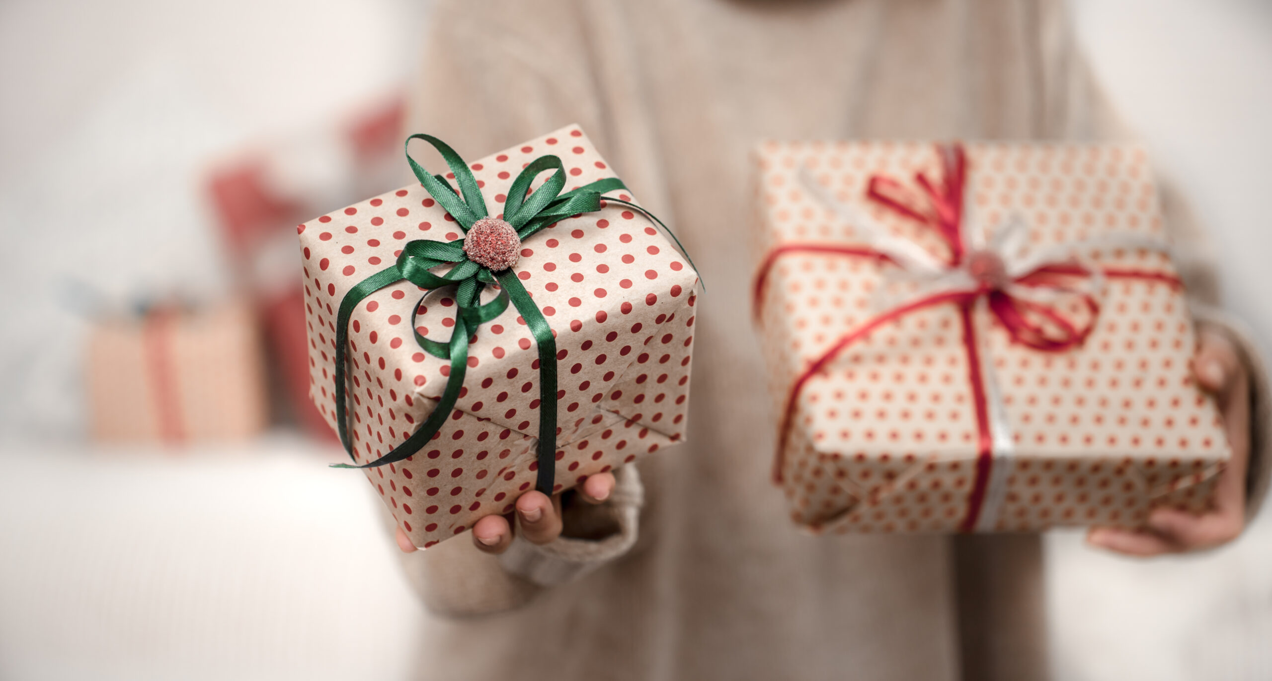 Hands holding gift boxes