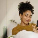 Woman smiling at smartphone
