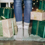 Feet in socks with presents on the floor