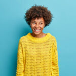 Woman smiling against blue background