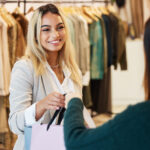 Customer taking shopping bag and smiling
